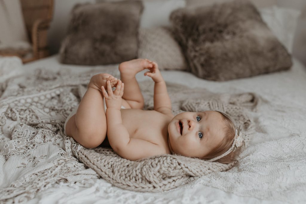 photo of baby grabbing feet
